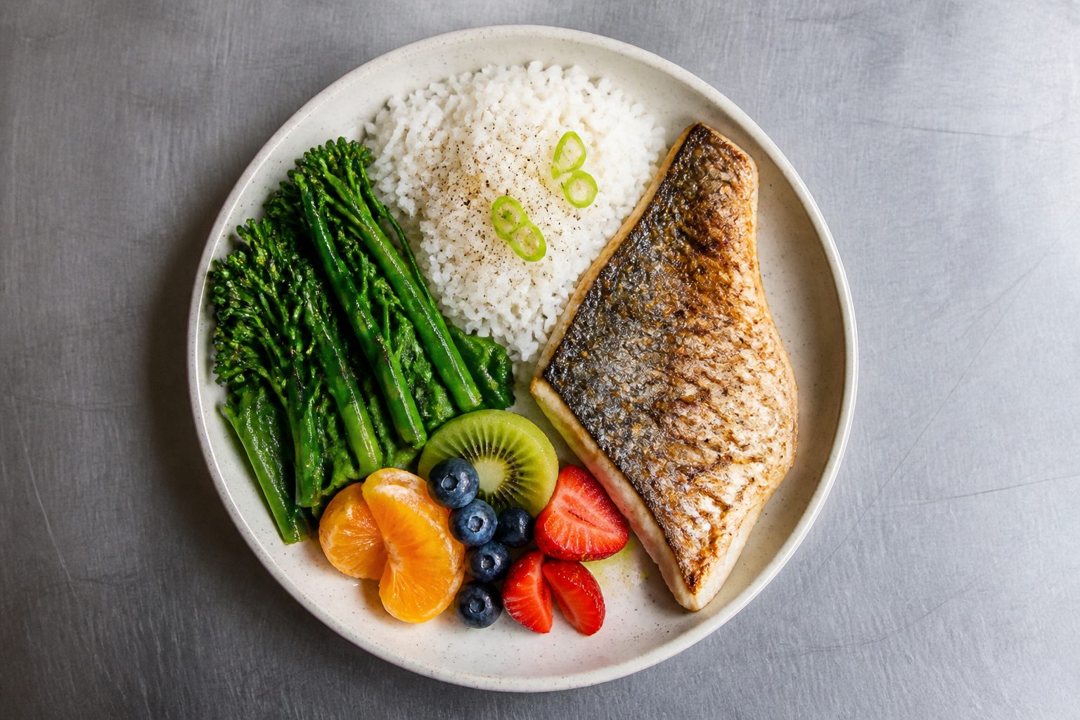 Performance meal of rice, grilled fish, and fresh vegetables